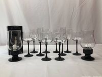 All glassware and photophores displayed on a white cloth background, showing the shape and size of each item.