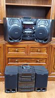 Full view of Panasonic stereo system with 2-way speakers on top shelf and Sony mini Hi-Fi system with speakers below
