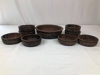 Front view of set showing one large bowl in the center with four smaller bowls on either side, arranged on white background