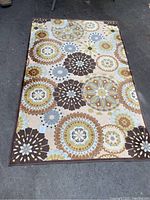 Top view of the sun pattern area rug showing the multicolored circle and floral-inspired design.
