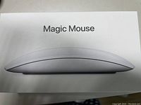 Photo of the unopened Apple Magic Mouse box showing the side profile image of the mouse and the words 'Magic Mouse' on top of the box.