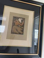 Framed print showing three stacked animals in totem style, fox, bird, and bear.