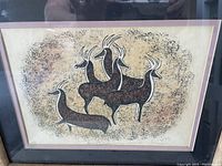 Framed drawing depicting four stylized Native American antelope, with signature and date visible in lower right corner.