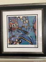 Full view of the framed owl print artwork, showing the owl on a branch with a colorful abstract background.