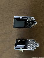 Close-up photo of a pair of Deco style earrings showing square black onyx stones with marcasite embellishments in silver setting.