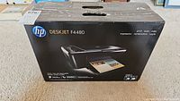 Box front view showing HP Deskjet F4480 model name and image of the printer with color print output.