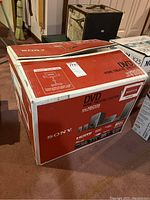Full boxed Sony Bravia DAV-HDZ235 DVD home theatre system showing front and top sides of box.