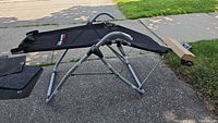 Core Lounge Xtreme exercise equipment set up outdoors showing the black mesh surface, tubular frame, and handles.