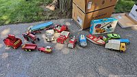 Overview of lot on pavement showing all toy vehicles and implements