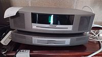 Two stacked Bose units: Wave Music System main unit on top, multi-disc CD changer below
