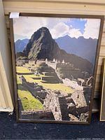 Front view of framed photo showing the ruins of Machu Picchu under a partly cloudy sky.