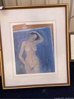 Full view of framed nude artwork showing the nude figure with a blue background and gold frame.