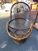 Top front view of one papasan chair showing rounded frame, spindles back and open seat area.