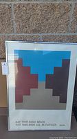 Framed signed limited edition print titled Canyon de Chelly by Walter Cooper, featuring geometric art in blue, brown, red, and beige tones with inspirational text.