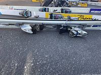 Close-up of multiple skis with bindings and brand markings, including Premia and Rossignol.