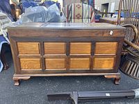 Front view of the solid hardwood trunk with paneled squares and short curved legs