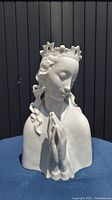 Front view of the porcelain Madonna statue showing the praying hands, serene face, and crown details.