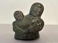 Front view of sculpture showing mother holding child