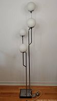 Full view of lamp showing four globes and square base
