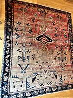 Full view of rug laid flat on hardwood floor.