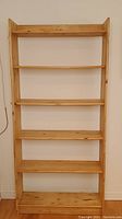 Front view of the pine wooden bookcase showing five shelves and full height.