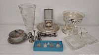 Full lot overview displaying crystal vase, multiple silver-plated dishes, miniature salt and pepper shakers in blue box