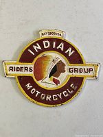 Front view of cast iron sign on white background showing circular border with text and profile