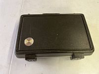 Closed black hard-shell carrying case with 'Bundy' logo on the top left corner