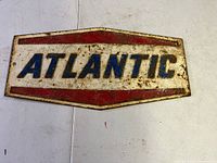 Front side of cast iron 'ATLANTIC' oil sign showing colors and lettering