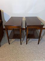 Front view of two identical wooden end tables side by side showing dark brown finish and rectangular shape