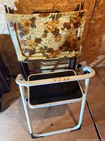 Four folding trays folded and held together with a floral caddy; step stool partially visible