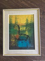 Framed abstract horse painting using green, yellow, blue and brown colors with beige fabric mat and gold frame.