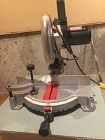 Front view showing the base with angle markers and locking mechanism