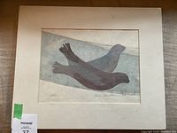 Full view of the woodblock print with matting showing two seals in profile on a watery background.