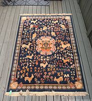 Full view of carpet on deck showing overall design, fringe and condition