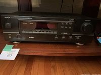 Front view of Denon DRA-375RD FM stereo receiver with power switch, remote sensor, tuning display, and speaker/phone controls.
