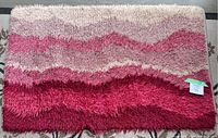 Full view of pink gradient shaggy Scandinavian Rya rug, rectangular shape, showing color gradation