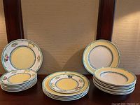 Overall view of all stacked French Garden dinnerware pieces showing bowls and plates in both Fleurence and Vienne patterns