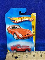 Front view of 2009 Hot Wheels Ferrari 250 GTO diecast car in original blister packaging with blue card and Hot Wheels logo
