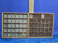 Two velvet-lined wooden display cases with 36 compartments each, seen from the top showing measurements with ruler for size reference.