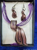 Photo of multicolor glass pendant necklace with matching earrings in box