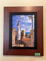 Full view of the framed print on canvas with the coastal scene, showing the reddish-brown wooden frame and black border, with a 20x16 inch size label.