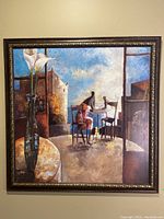 Square framed print depicting a café scene with a vase and figure at a table.