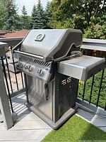 Full view of stainless steel Napoleon Rogue gas barbecue grill on deck