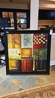 Frontal photo of the framed textured abstract stretched canvas wall art showing all nine divided blocks with various colors and textures.