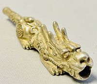 Close-up photo showing the dragon head details of the silver plated pipe, including the open mouth and textured scales.