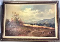 Full view of the framed oil painting showing the entire rural landscape scene and its surroundings.