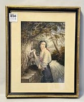 Framed Victorian print showing woman in period attire by stone well with natural background, frame gold-toned with minor wear visible