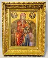 Front view of the gilded framed religious print showing Virgin Mary holding Child Jesus with two angelic medallions above