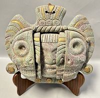 Front view of handmade Mayan Aztec pottery wall art plaque showing detailed face design with textured, crackled glaze and subtle color accents.